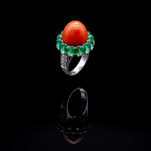 Lot 112 White gold, coral, diamonds and emerald ring